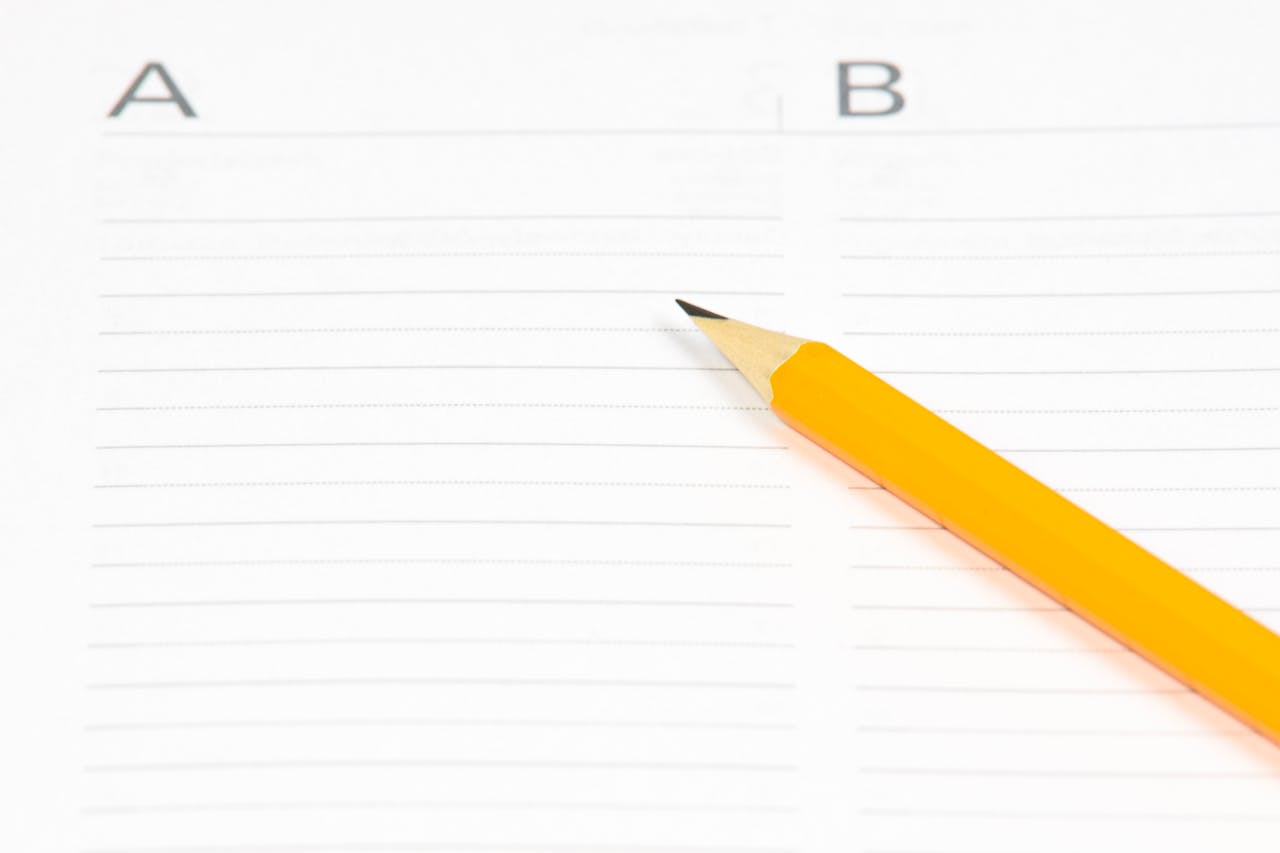 Yellow Pencil on White Ruled Paper